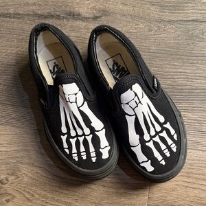 Vans Kids Black Custom Slip-On Sneakers with White Skeleton Foot Graphic